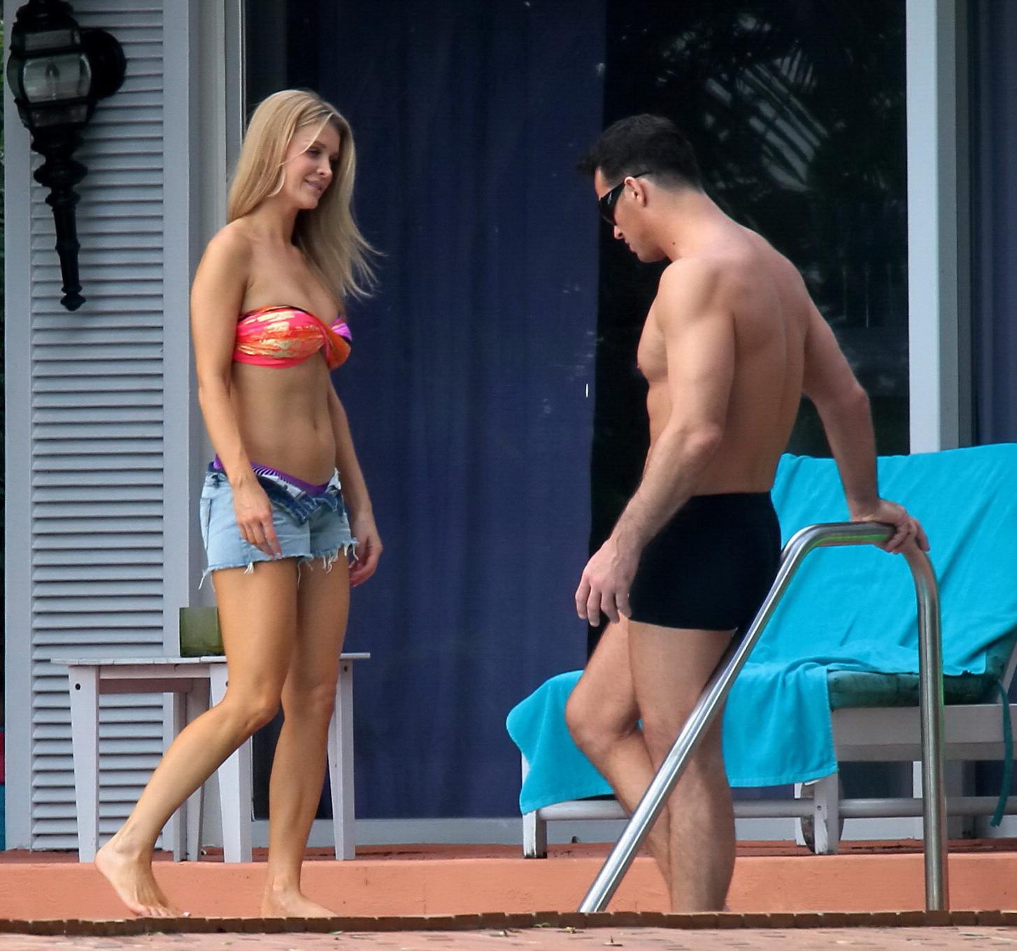 16P Joanna Krupa wearing a strapless bikini top and hotpants poolside in Miami