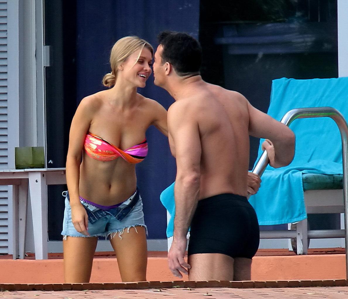 16P Joanna Krupa wearing a strapless bikini top and hotpants poolside in Miami