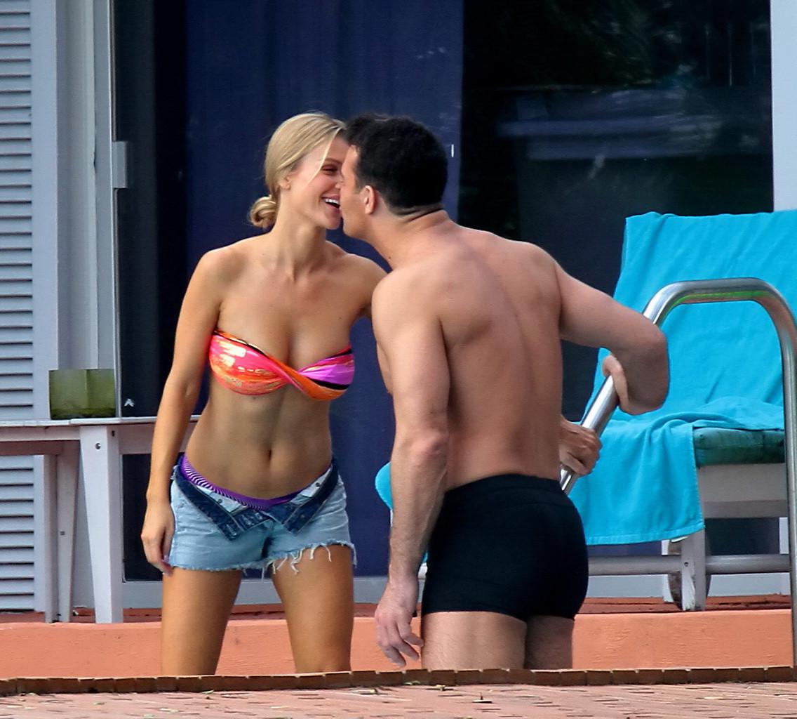 16P Joanna Krupa wearing a strapless bikini top and hotpants poolside in Miami