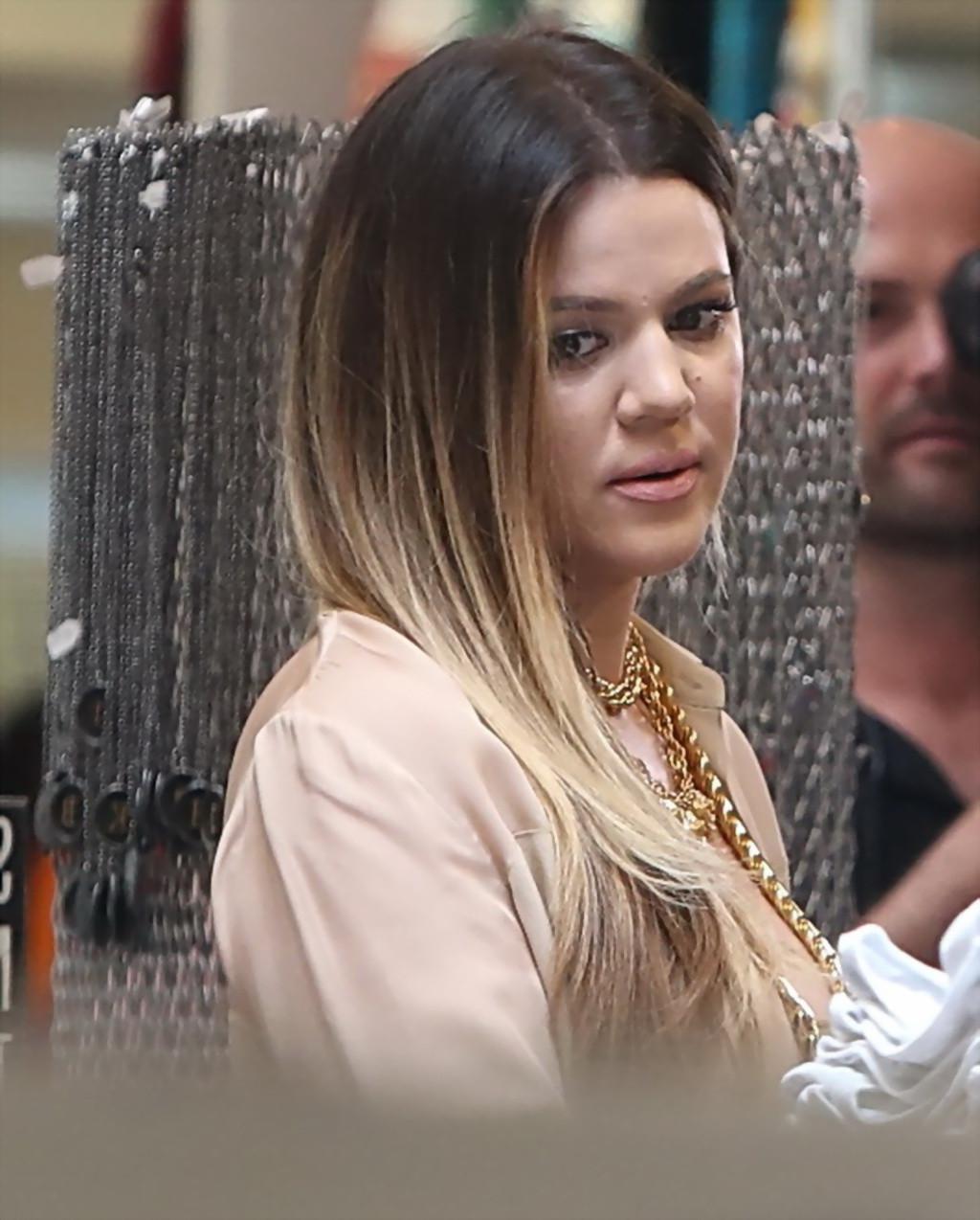 16P Khloe Kardashian braless wearing tight see-through top and jeans while shopping 