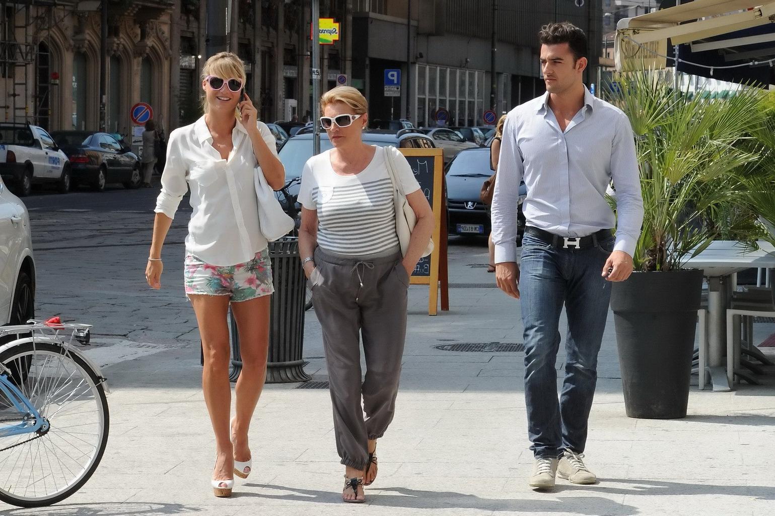 15P Michelle Hunziker cleavy and leggy in a see-through shirt and skimpy floral shor