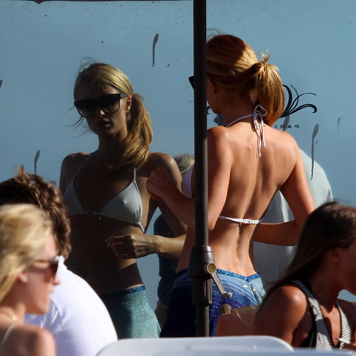 16P Paris Hilton showing her hard pokies in white transparent bikini top on the beac