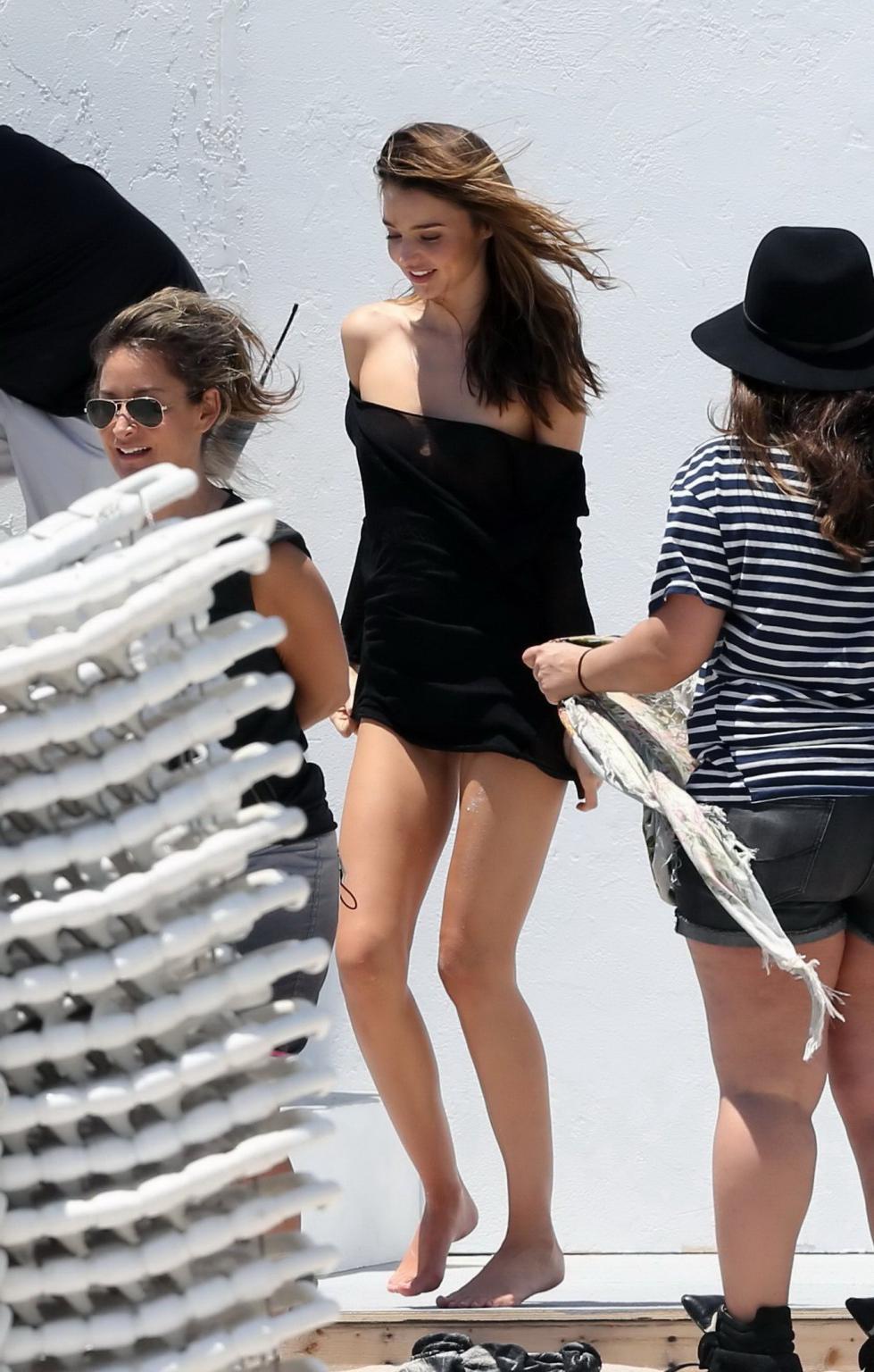 16P Miranda Kerr showing off her boobs downblouse while shooting in some black monok