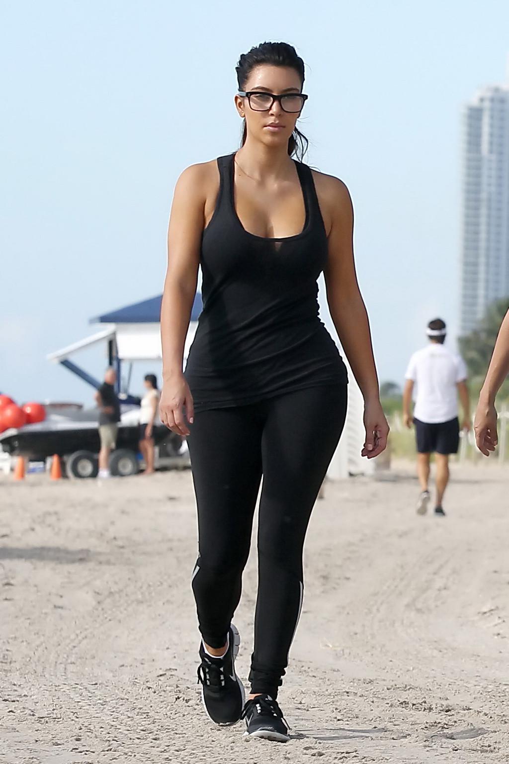 10P Kim Kardashian showing her huge boobs in tight see-through top and tights while 