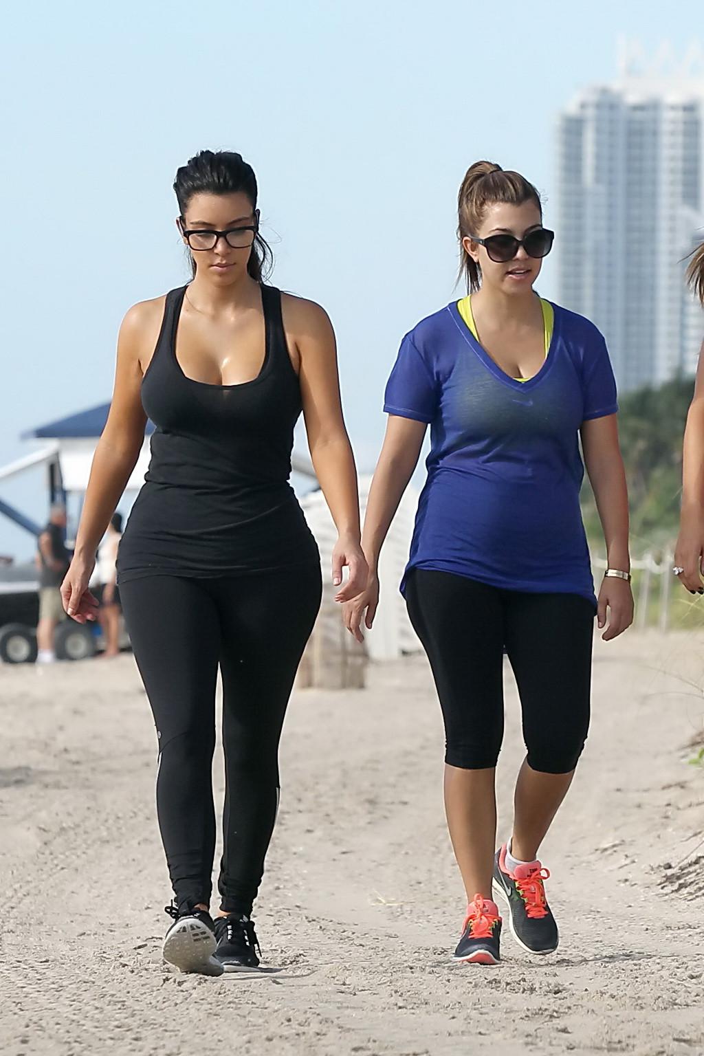 10P Kim Kardashian showing her huge boobs in tight see-through top and tights while 