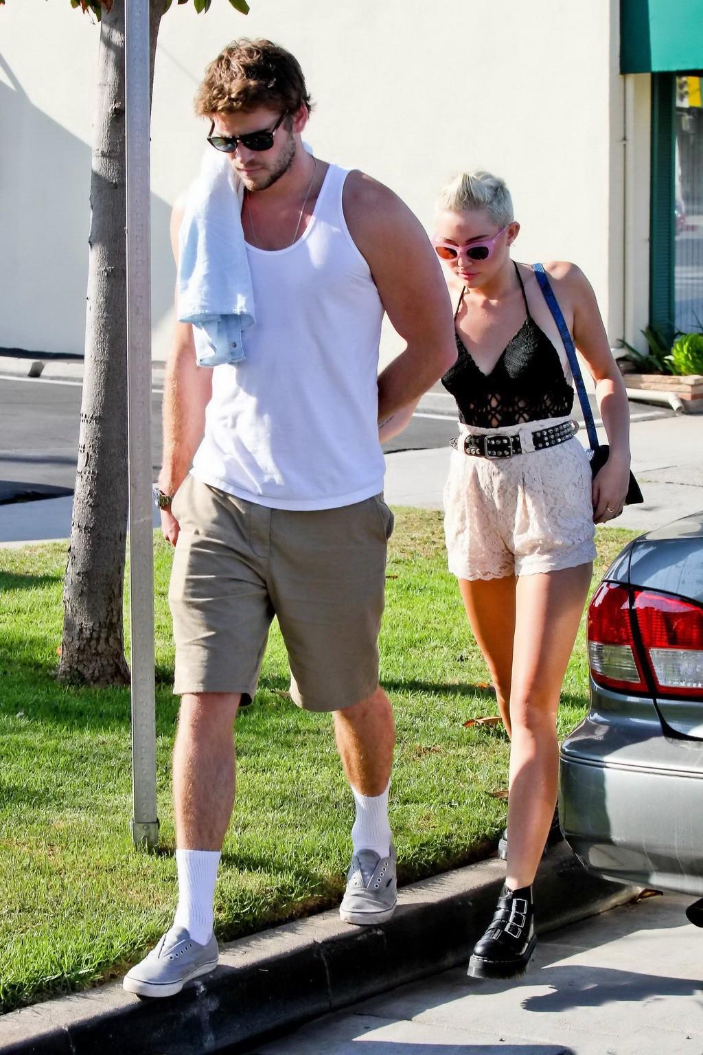 10P Miley Cyrus braless showing side boob in a partially see-through tiny top and sh