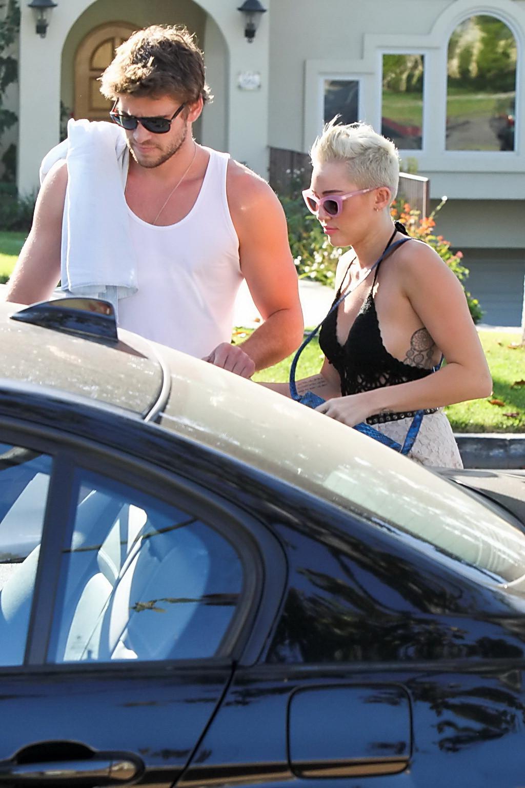 10P Miley Cyrus braless showing side boob in a partially see-through tiny top and sh