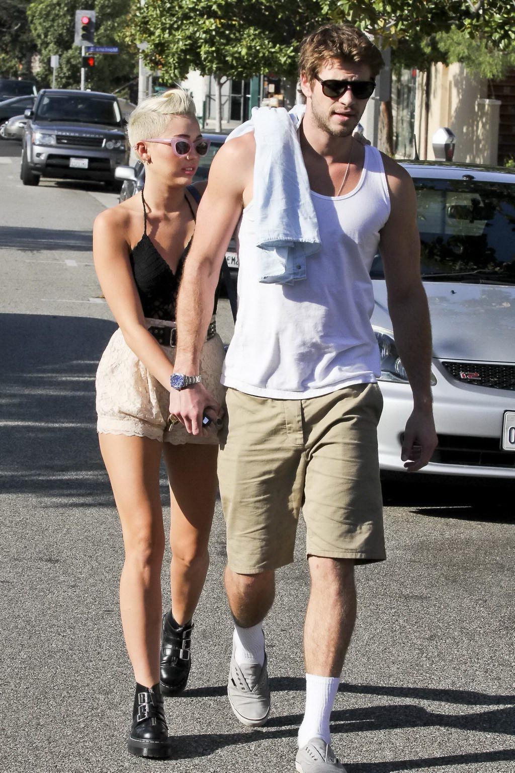 10P Miley Cyrus braless showing side boob in a partially see-through tiny top and sh