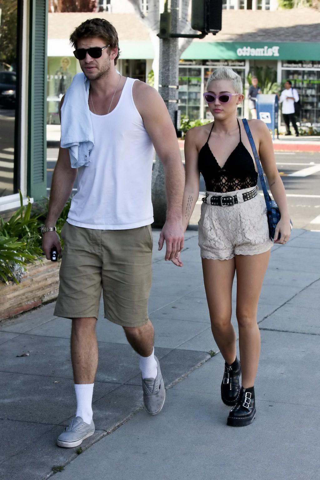10P Miley Cyrus braless showing side boob in a partially see-through tiny top and sh