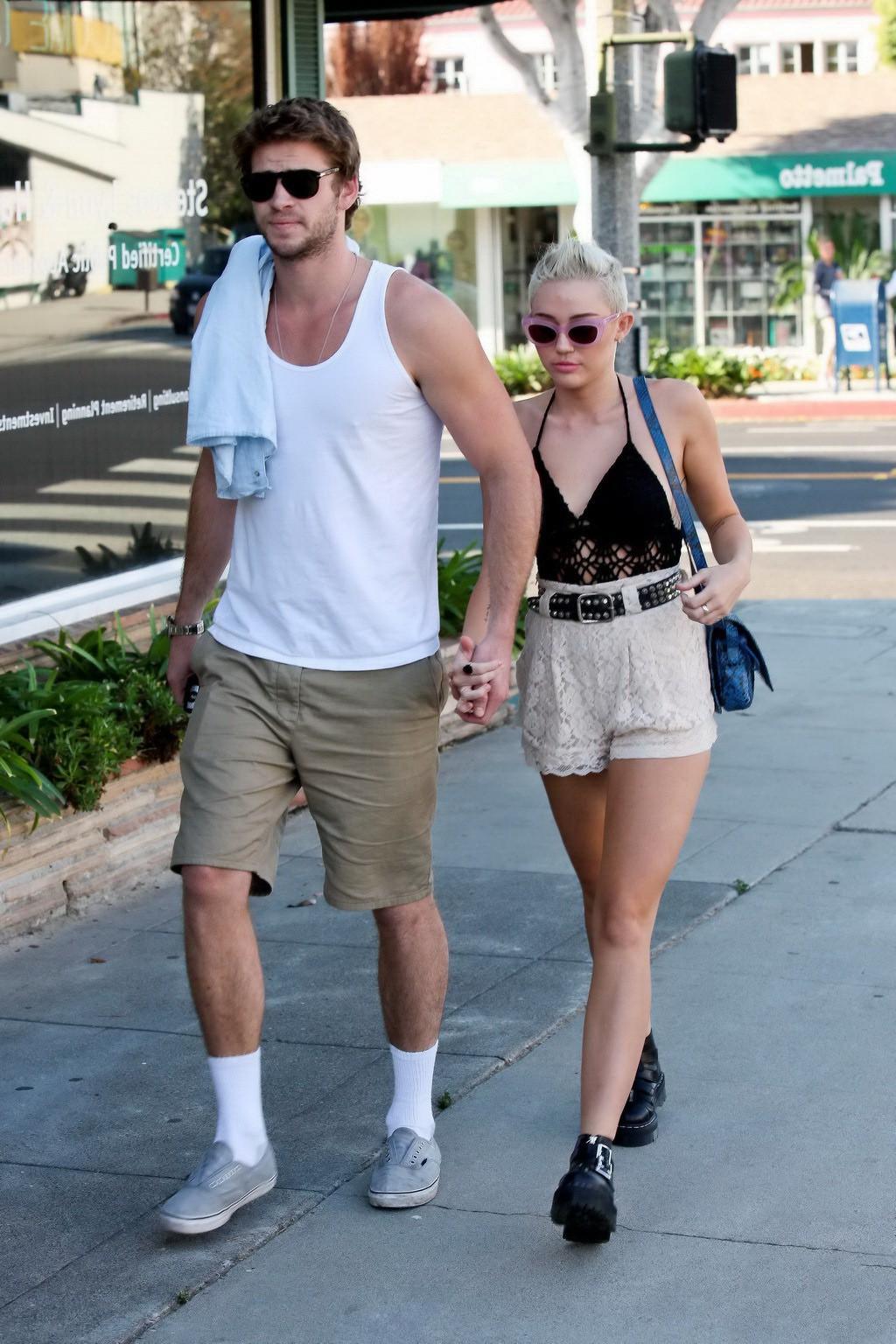10P Miley Cyrus braless showing side boob in a partially see-through tiny top and sh