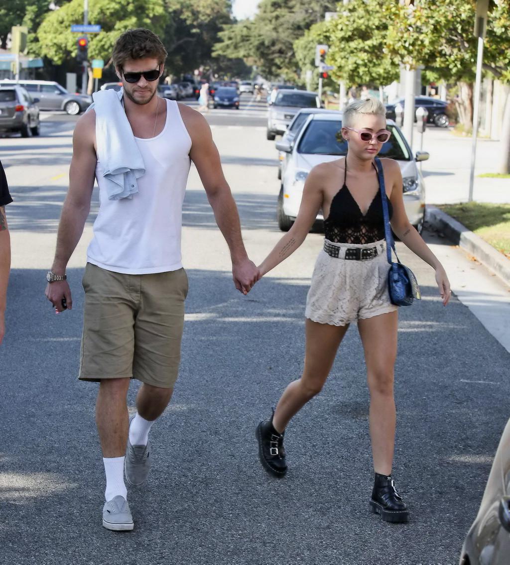 10P Miley Cyrus braless showing side boob in a partially see-through tiny top and sh
