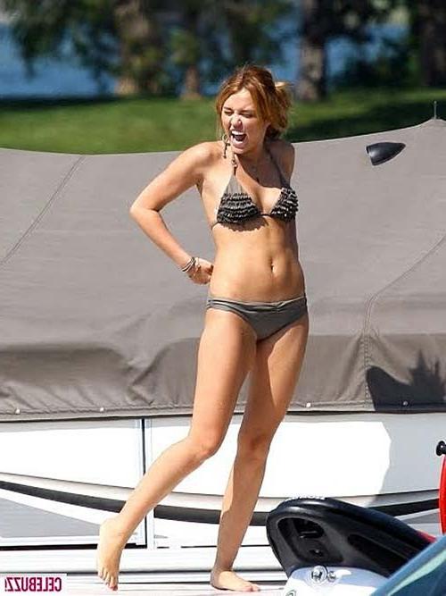 10P Miley Cyrus exposing her tattoo and boobs in see thru