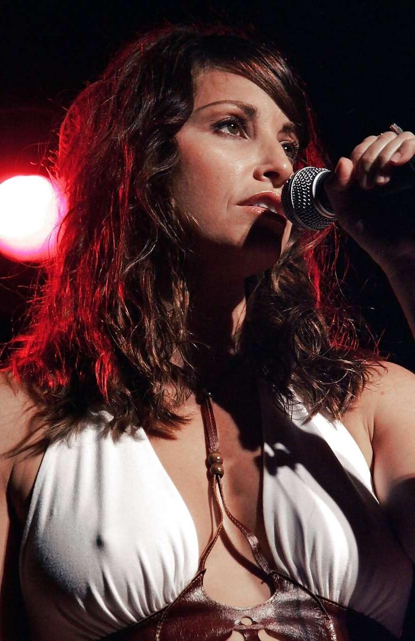 10P Gina Gershon showing her tits in see thru and posing in stockings