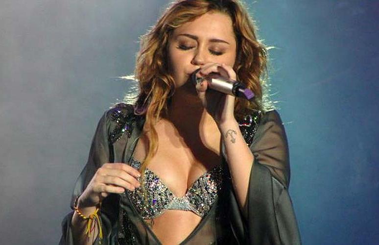16P Miley Cyrus exposing sexy body and hard nipples in see thru blouse