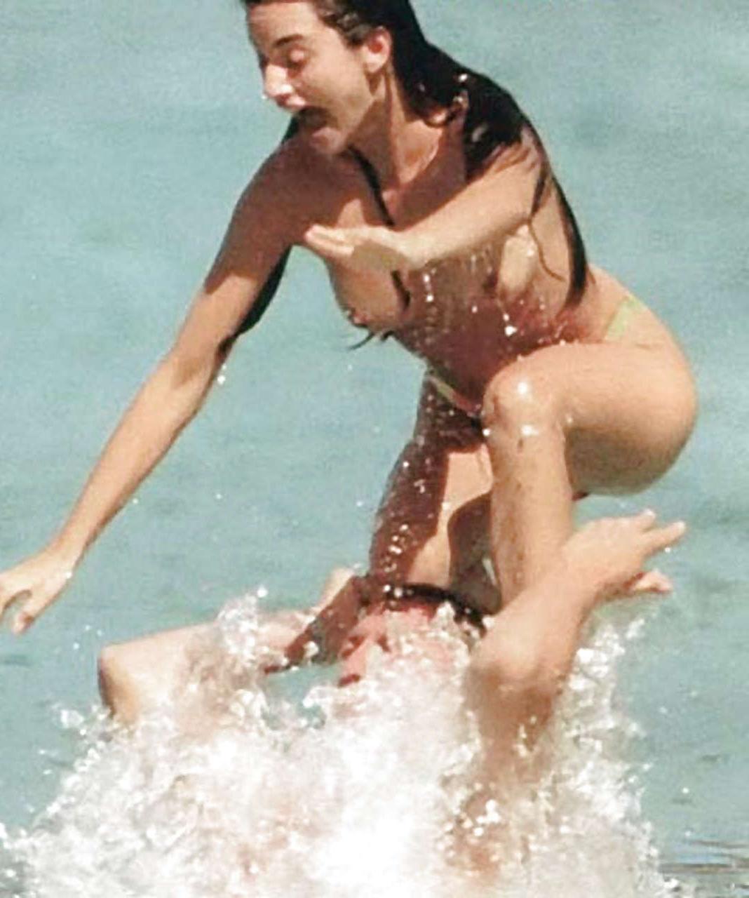 16P Penelope Cruz giving paparazzi great view on her tits on beach
