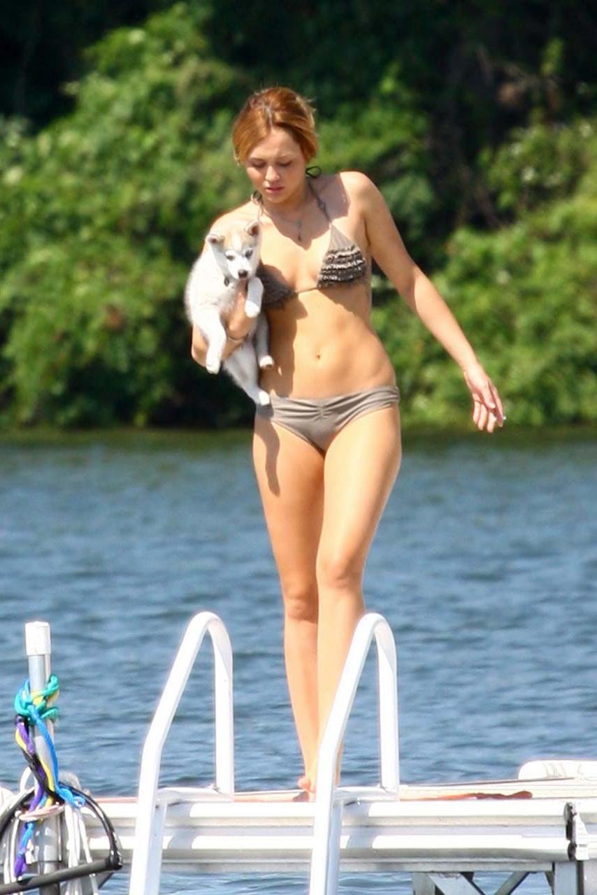 16P Miley Cyrus smoking cigars and showing her sexy body in bikini on lake