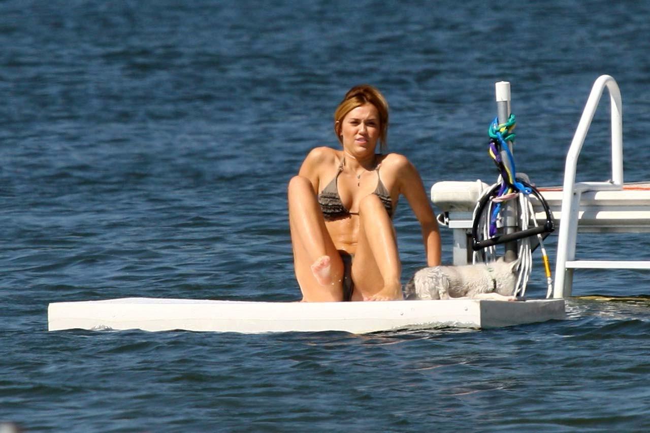 16P Miley Cyrus smoking cigars and showing her sexy body in bikini on lake