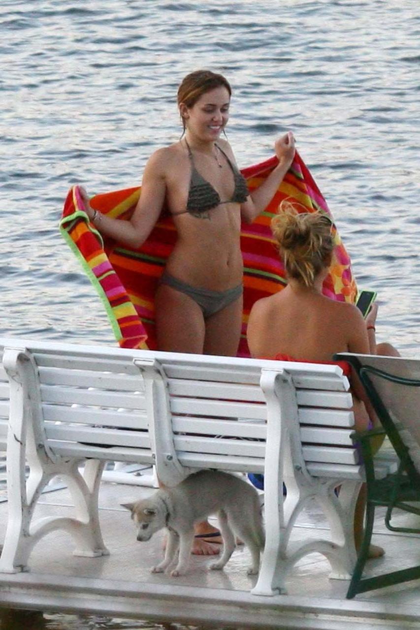 16P Miley Cyrus smoking cigars and exposing her hard nipples in see thru blouse