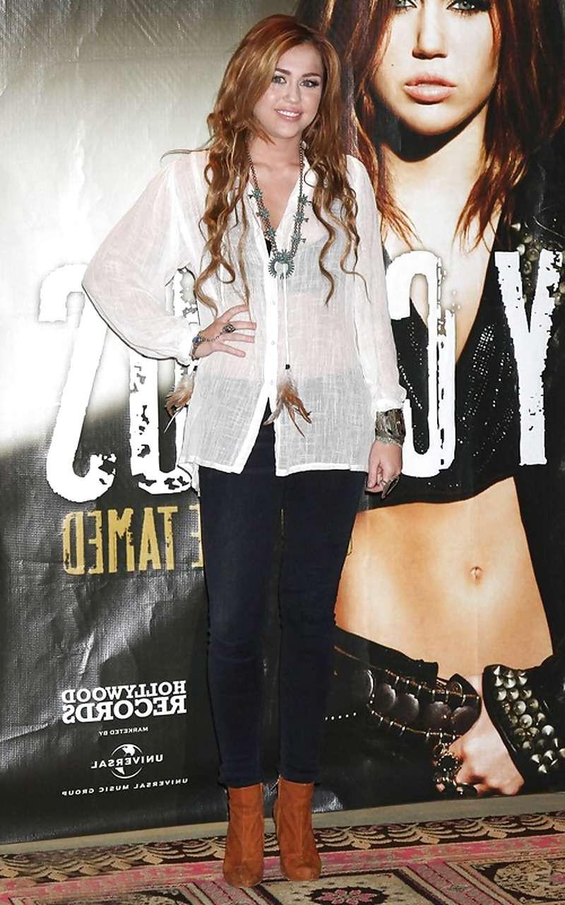 16P Miley Cyrus looking sexy in shorts and stockings and posing in see thru dress