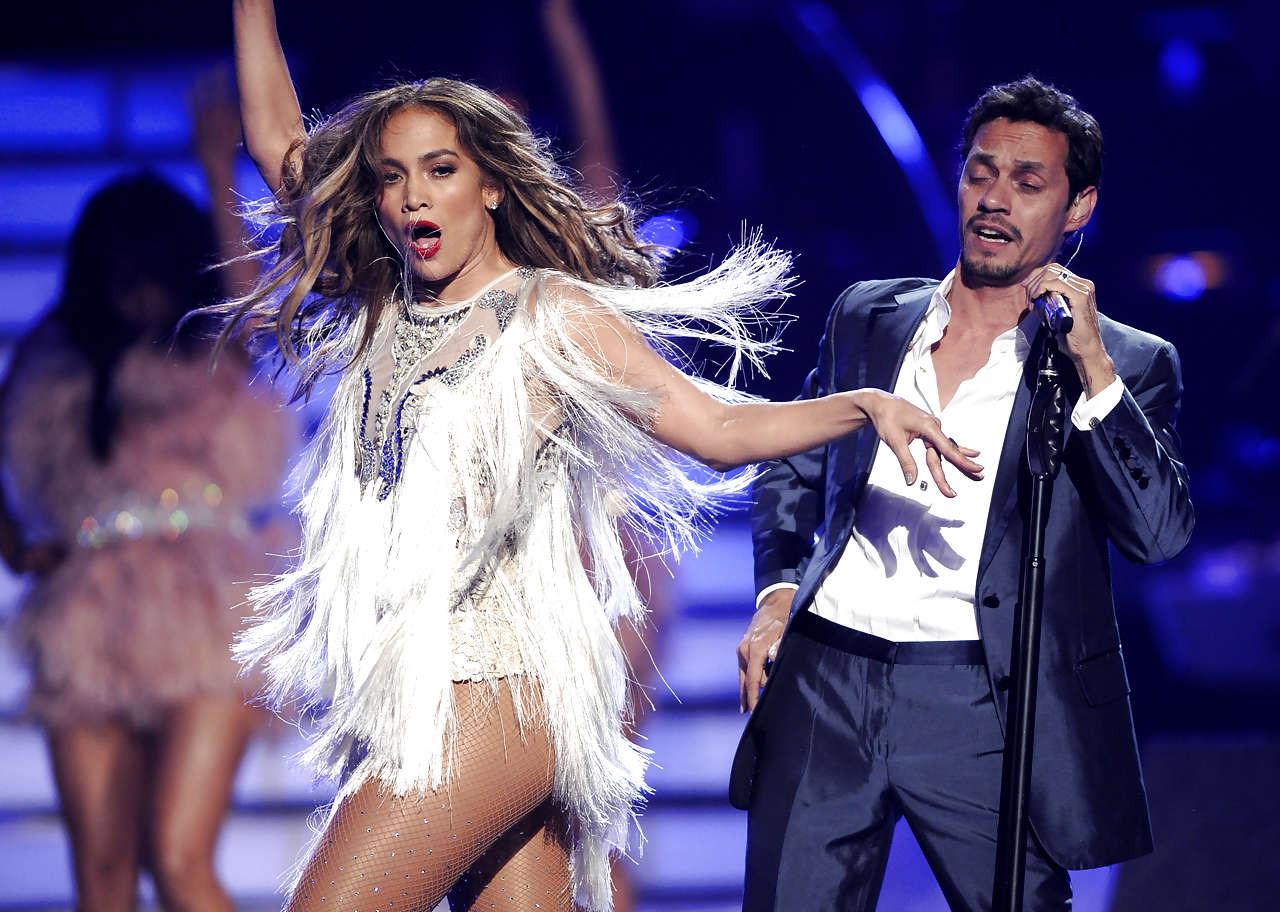 16P Jennifer Lopez exposing her great ass in mini skirt and tits in see thru