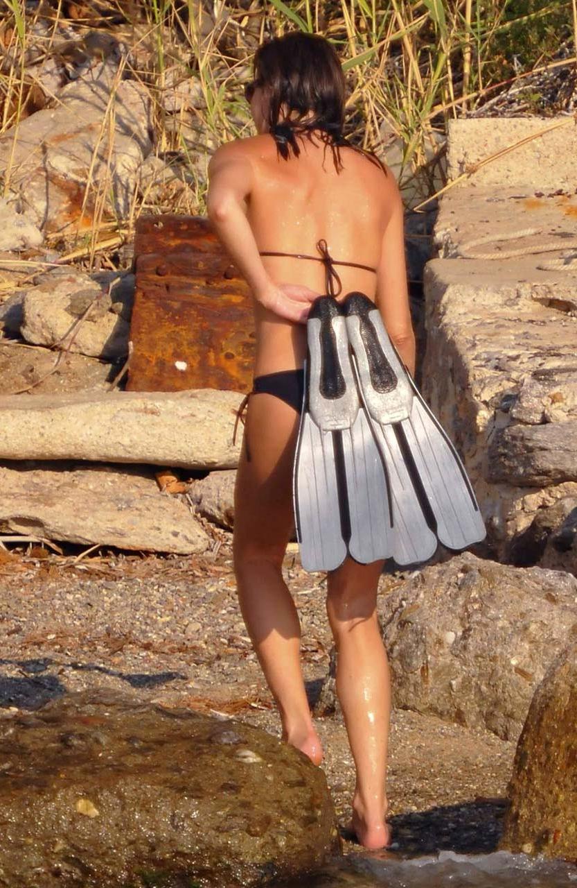 16P Carla Bruni showing her pookies in wet see thru bikini top on beach