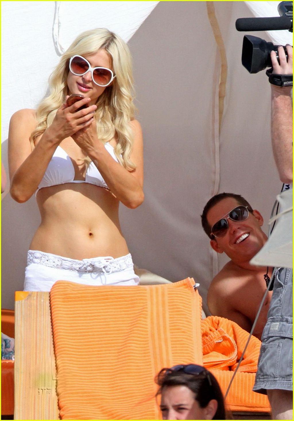 16P Paris Hilton wearing sexy white bikini  see-through shorts at the beach in Cabo 