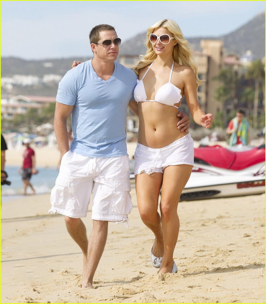 16P Paris Hilton wearing sexy white bikini  see-through shorts at the beach in Cabo 