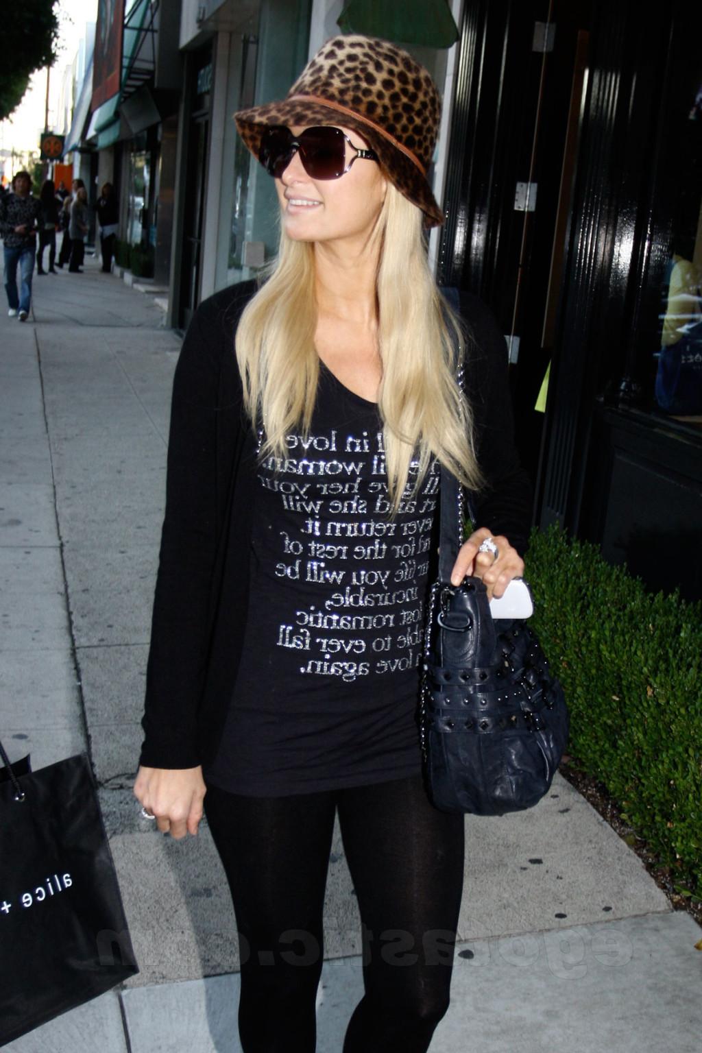 16P Paris Hilton showing off her ass in see-through tights while shopping