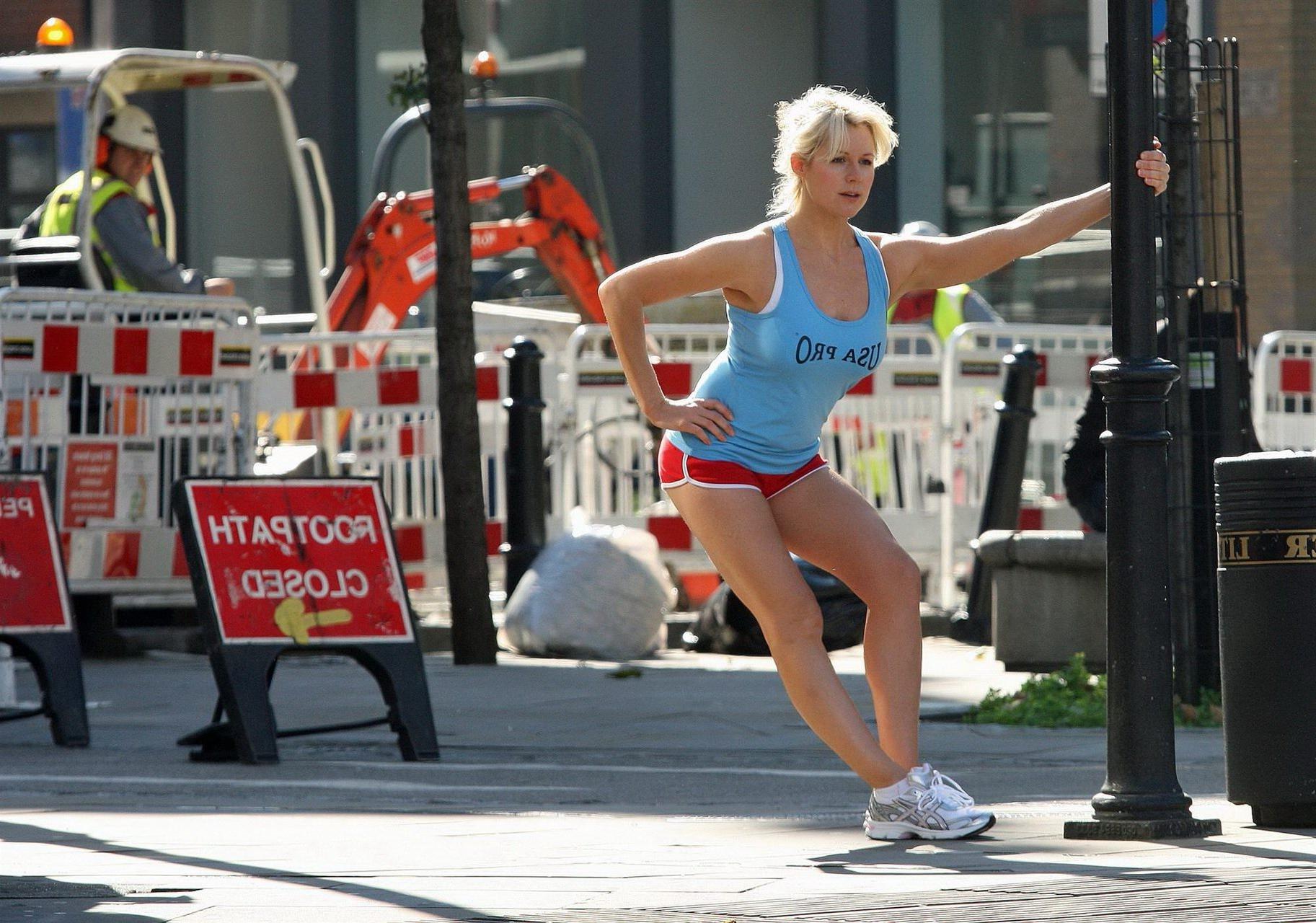 16P Abi Titmuss in shorts  tank-top jogging  stretching on the streets of London