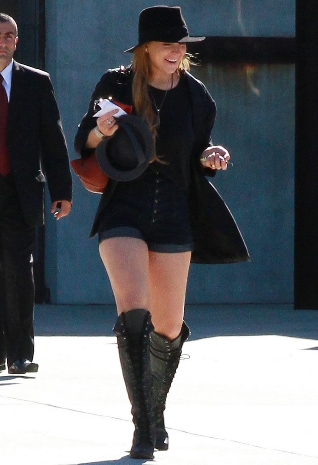 16P Lindsay Lohan braless wearing see through top, denim shorts  knee high boots at 