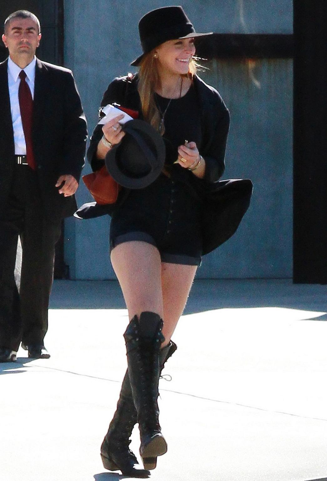 16P Lindsay Lohan braless wearing see through top, denim shorts  knee high boots at 