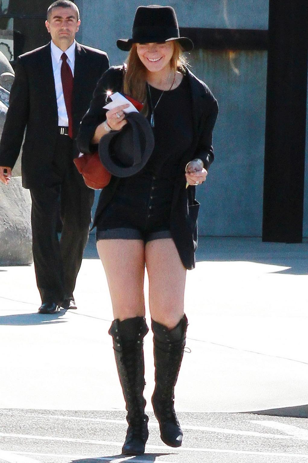 16P Lindsay Lohan braless wearing see through top, denim shorts  knee high boots at 