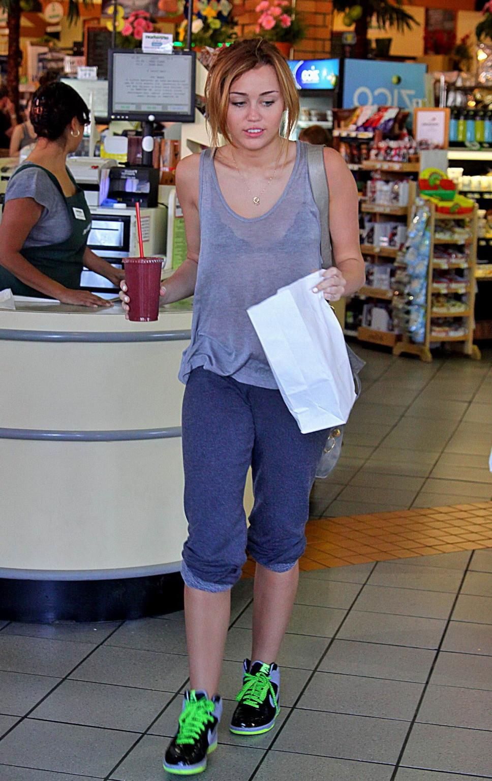 16P Miley Cyrus in black bra  see-through top at Erewhon Natural Foods grocery store