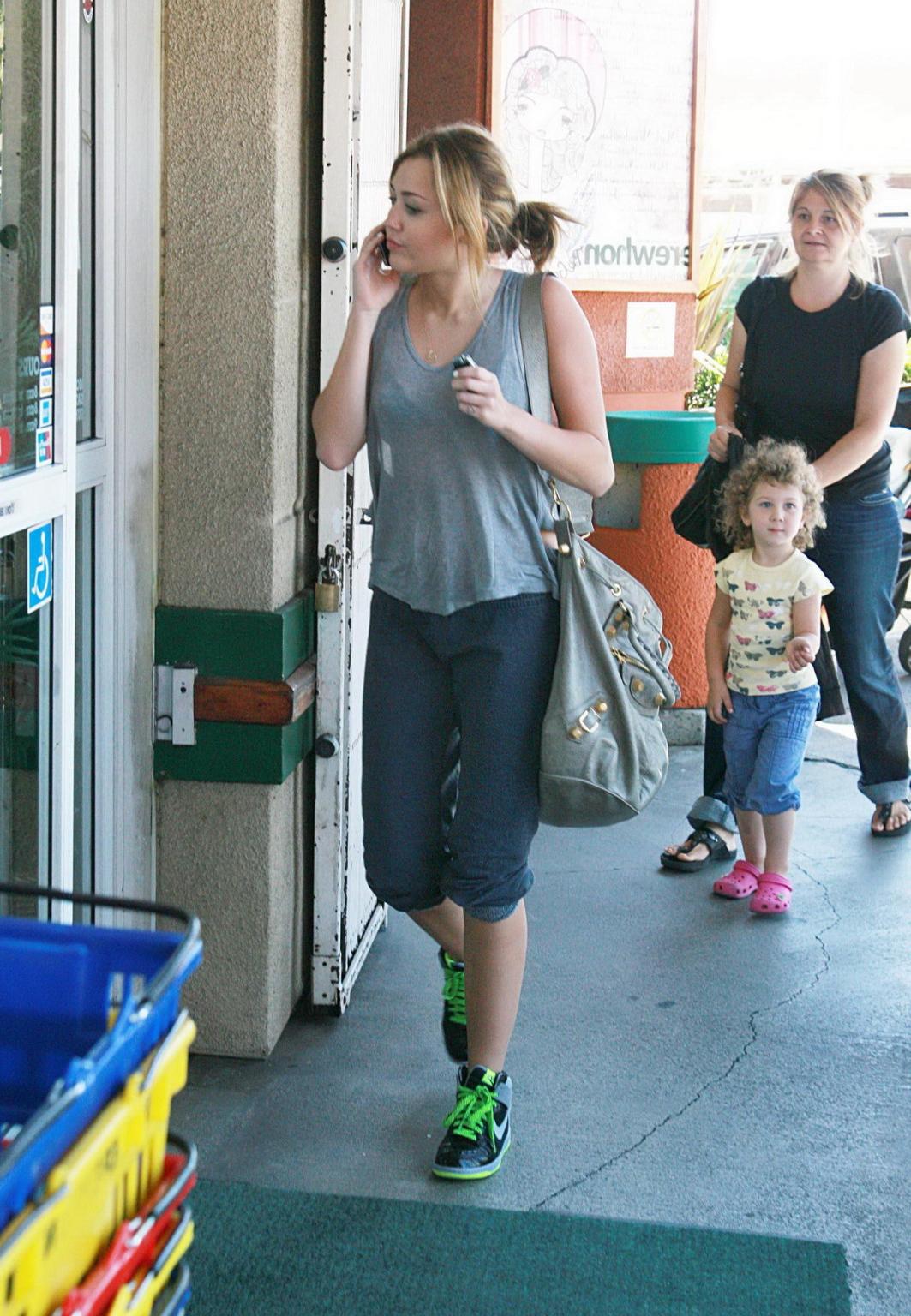 16P Miley Cyrus in black bra  see-through top at Erewhon Natural Foods grocery store