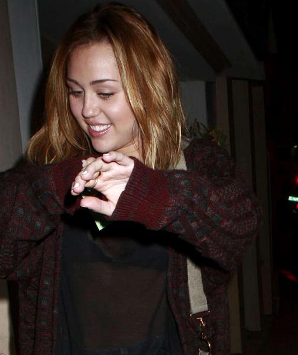 16P Miley Cyrus exposing her fucking sexy legs and nice tits in see thru shirt