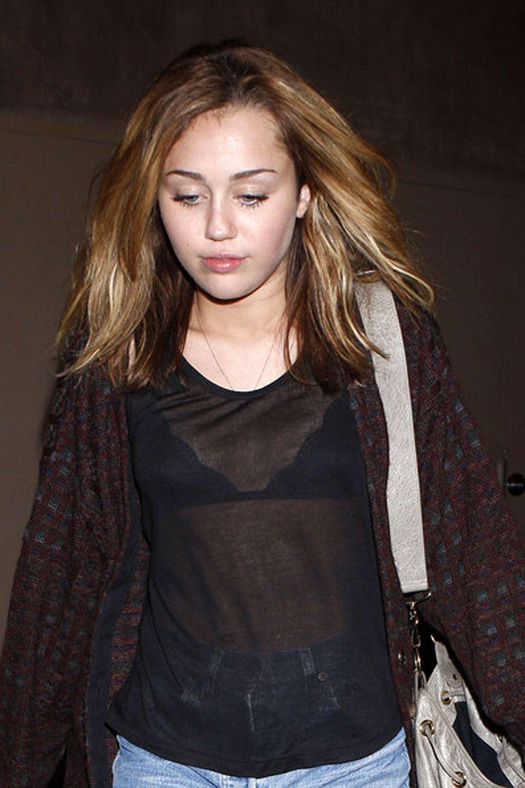 16P Miley Cyrus exposing her fucking sexy legs and nice tits in see thru shirt
