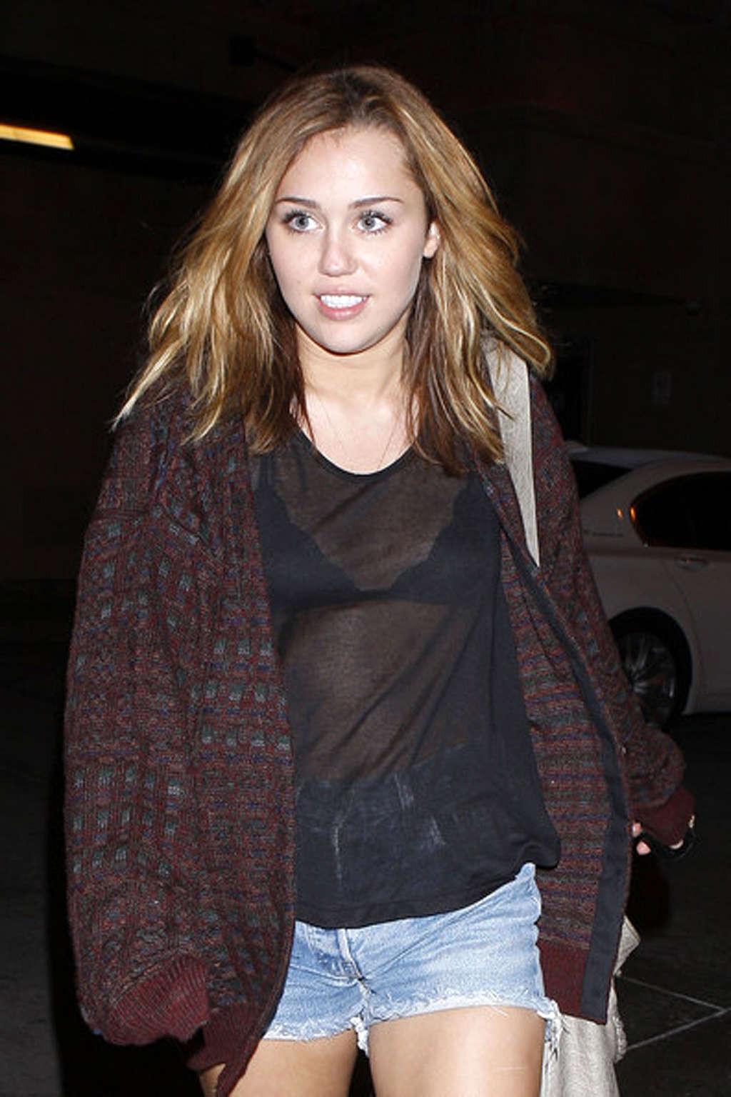16P Miley Cyrus exposing her fucking sexy legs and nice tits in see thru shirt