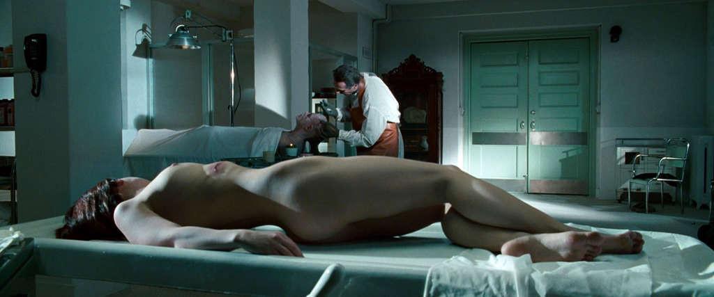 10P Christina Ricci reveals her nice small tits while lie on desk in movie