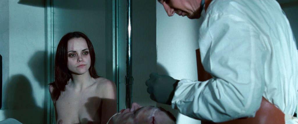 10P Christina Ricci reveals her nice small tits while lie on desk in movie
