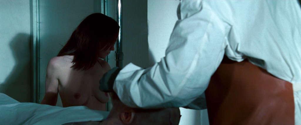 10P Christina Ricci reveals her nice small tits while lie on desk in movie
