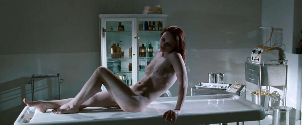 10P Christina Ricci reveals her nice small tits while lie on desk in movie