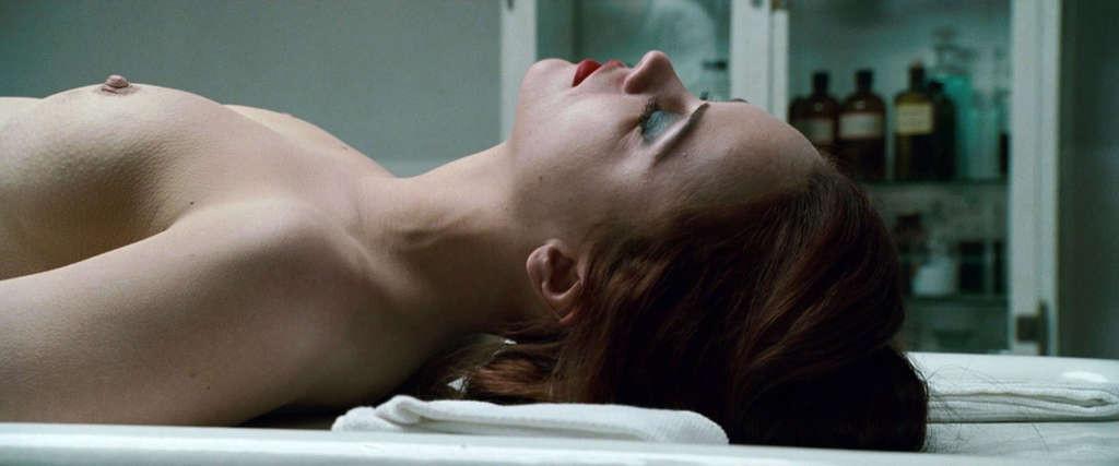 10P Christina Ricci reveals her nice small tits while lie on desk in movie