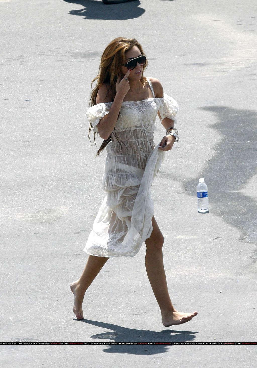 16P Miley Cyrus in thong and see thru dress and almost upskirt
