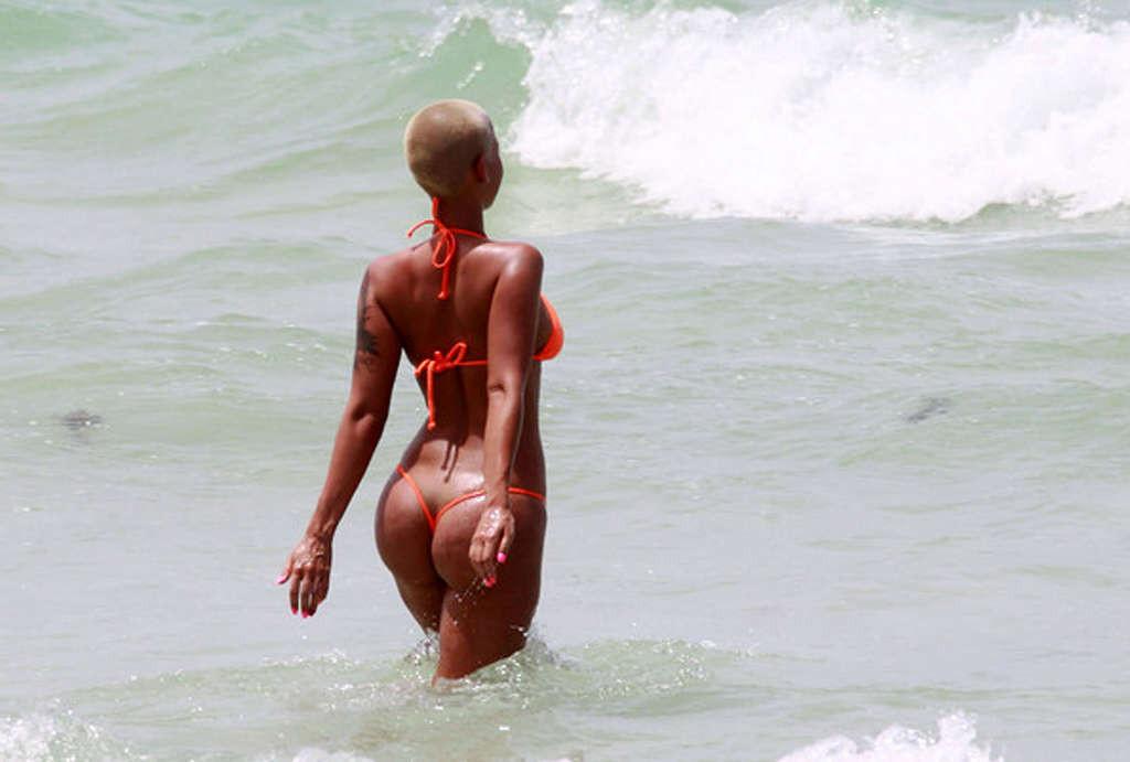 10P Amber Rose exposing her big tits and ass in thong and posing sexy in see thru dr