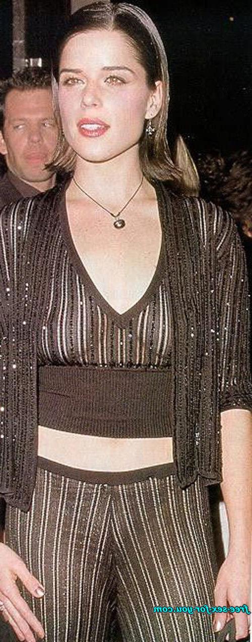 16P Neve Campbell posing sexy in black stockings and see thru dress
