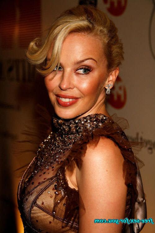 16P Kylie Minogue showing her tits and posing in see thru dress
