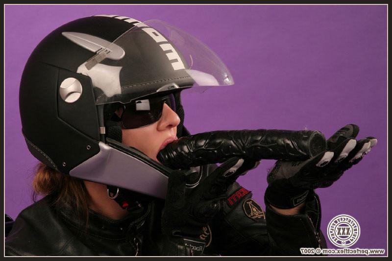 17P Flexible lady in a helmet stuffing herself with huge black dildo