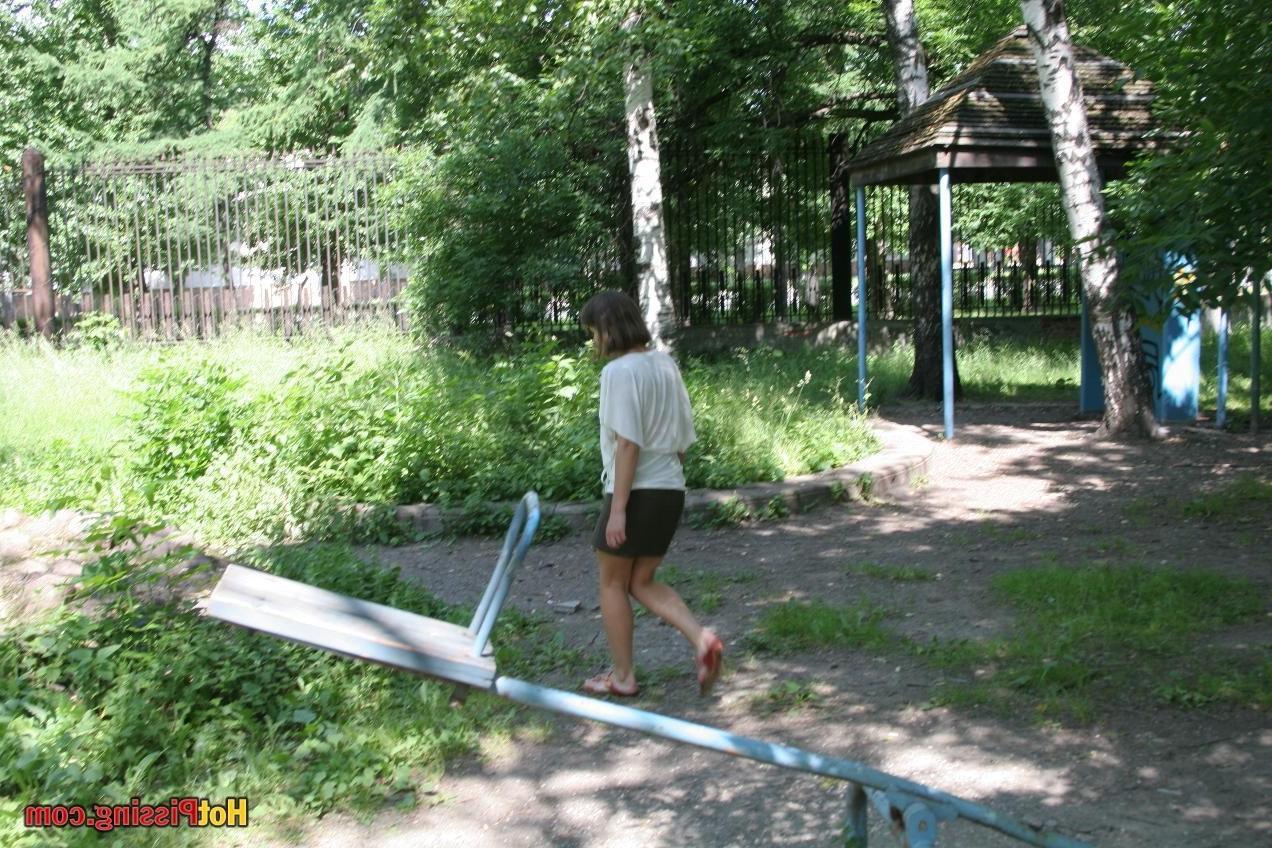 10P Coy babe empties her full bladder while balancing on the public rocks