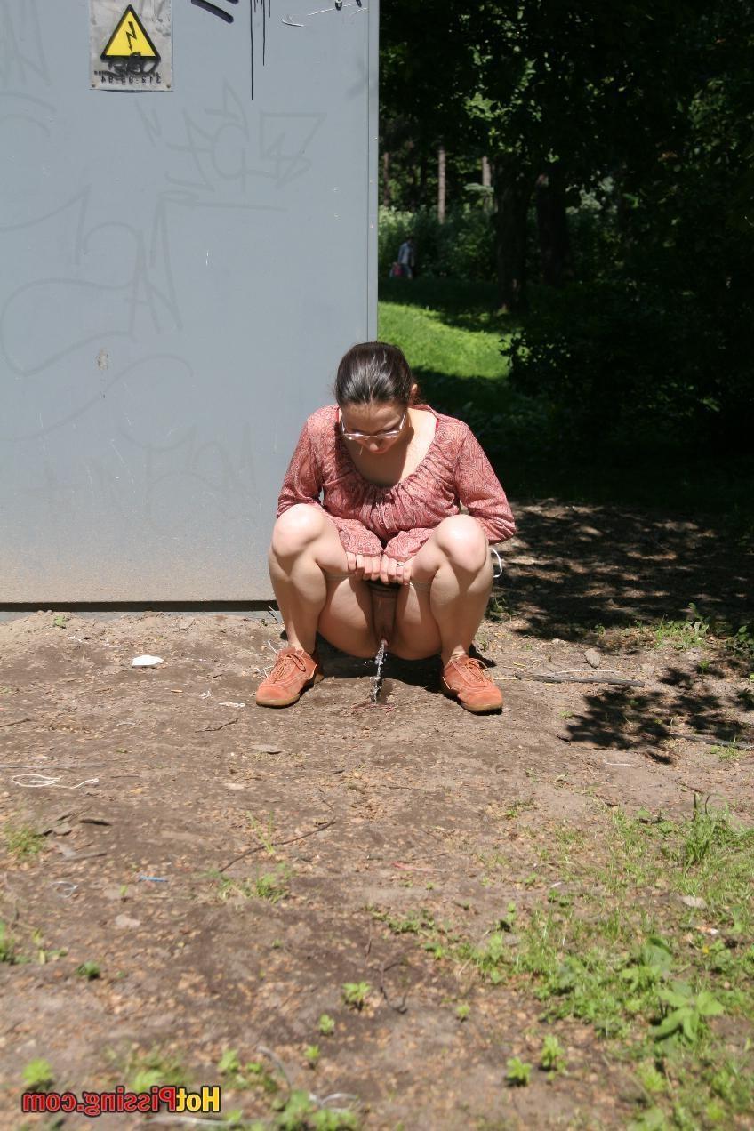 15P Cutie in glasses breaks her park walk and does a wee-wee cautiously