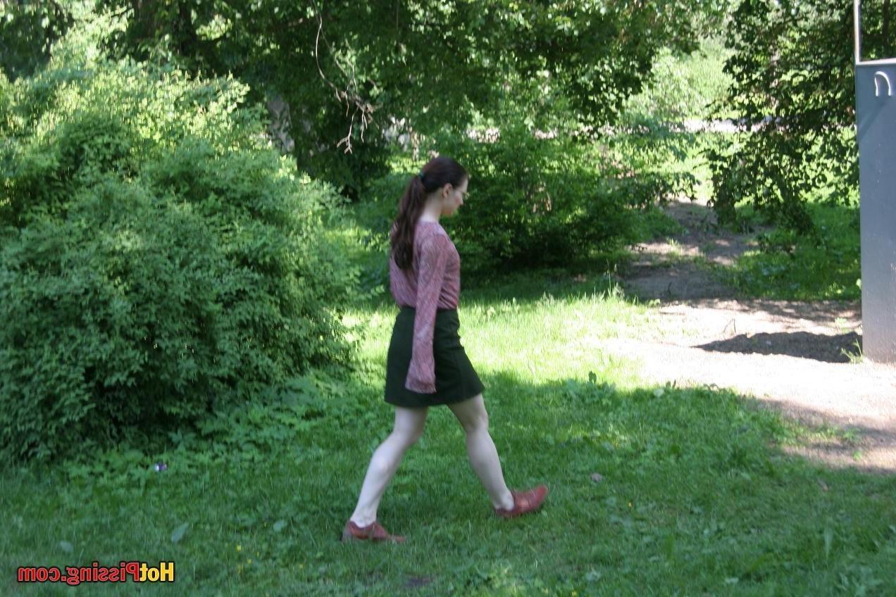 15P Cutie in glasses breaks her park walk and does a wee-wee cautiously
